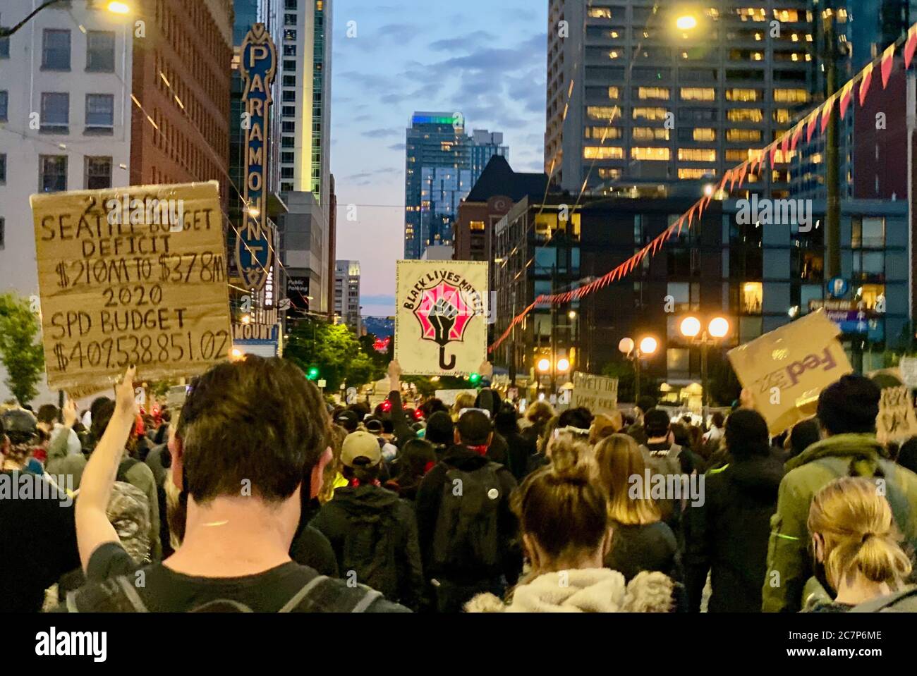 Seattle, Washington, USA. 4th July, 2020. Hundreds of protestors marched the evening of July 4th for Black Lives Matter, led by the Black Femmes, from CHOP/CHAZ Zone, which was recently taken over by Seattle Police, to Westlake Center Park, where they held a vigil for two protestors hit by a car early that morning while holding a rally on Interstate 5. Credit: Amy Katz/ZUMA Wire/Alamy Live News Stock Photo