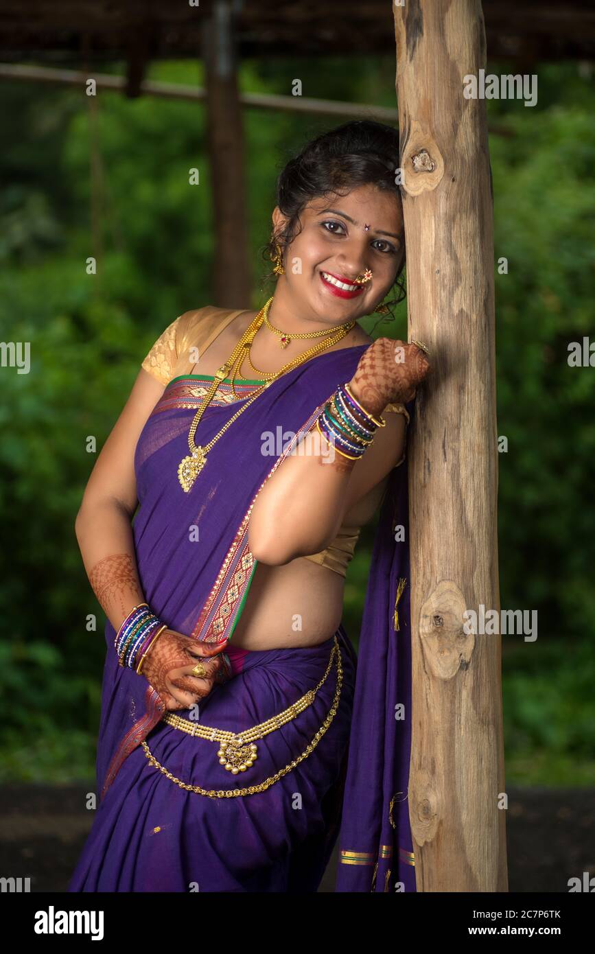 beautiful indian young girl in traditional saree posing outdoors 2C7P6TK