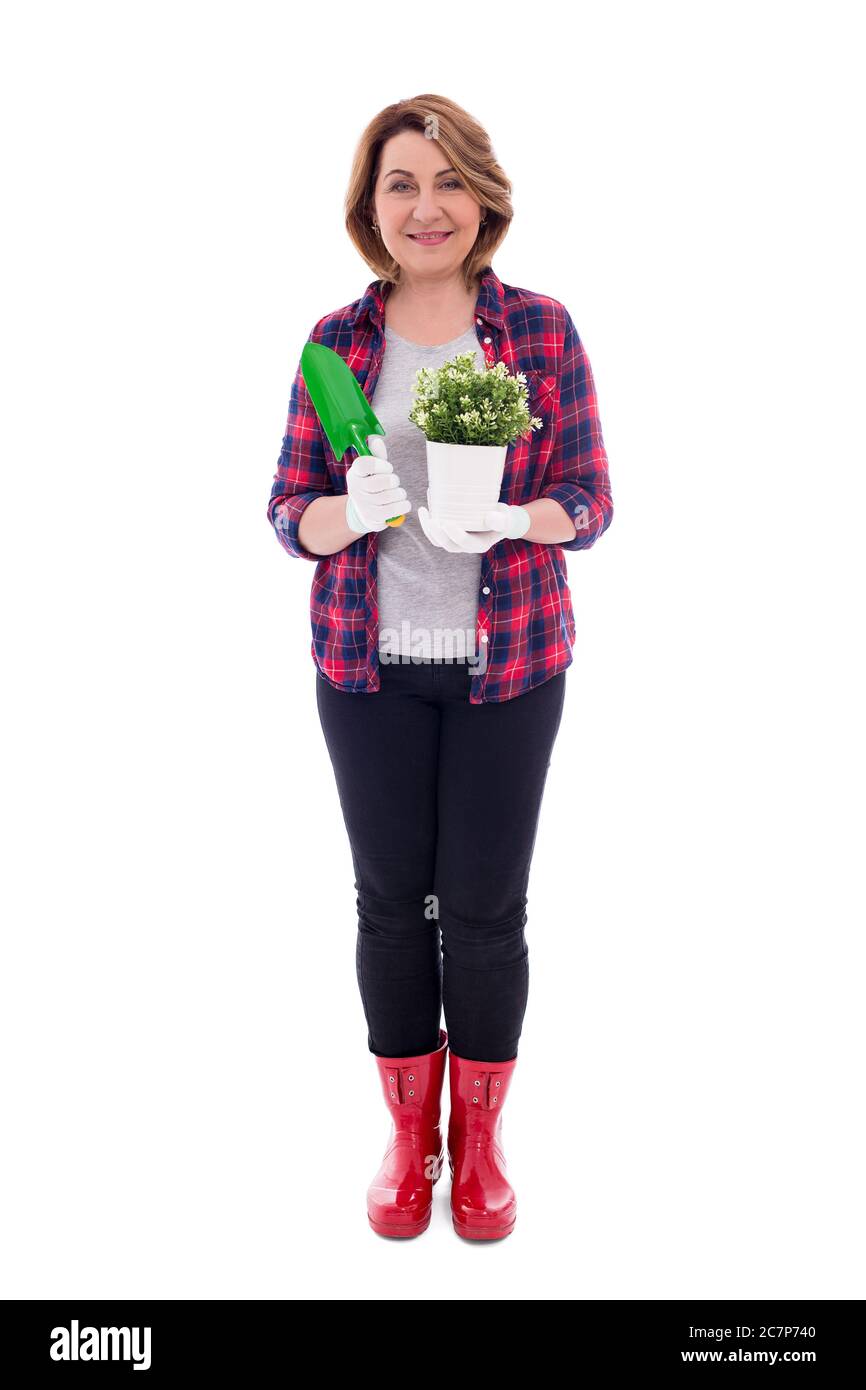 full length portrait of smiling mature woman with potted plant and ...