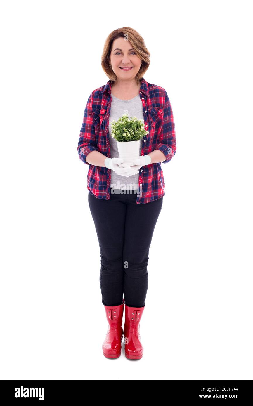 full length portrait of smiling mature woman gardener with potted plant ...