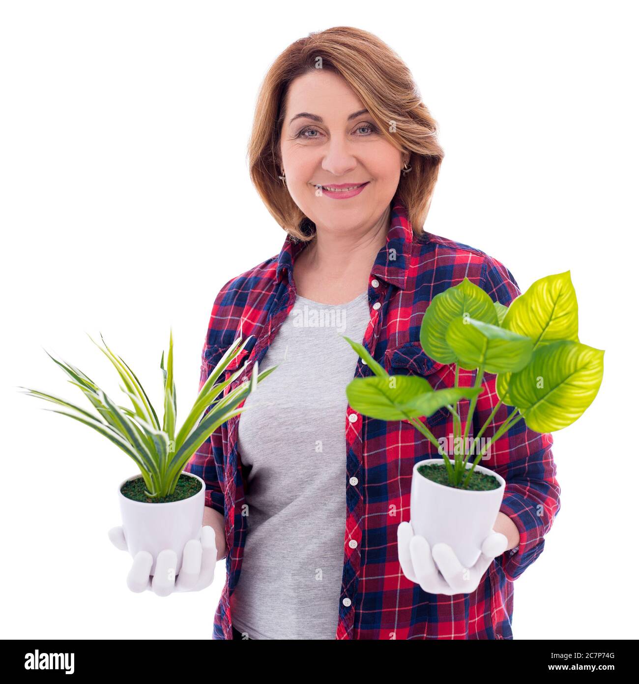 portrait of happy mature woman gardener with potted plants isolated on ...