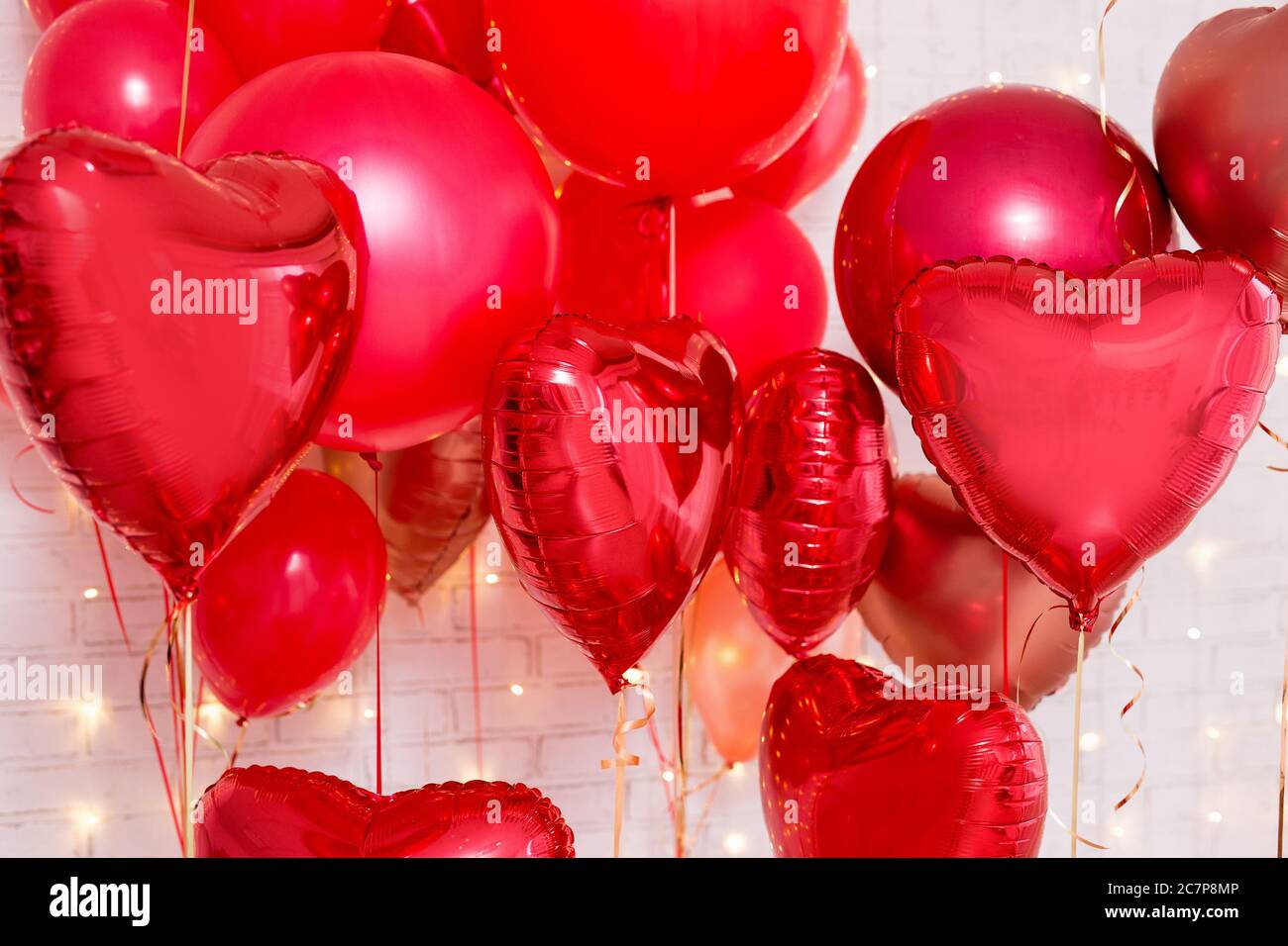 Valentine's day background - red heart shaped balloons over white brick ...