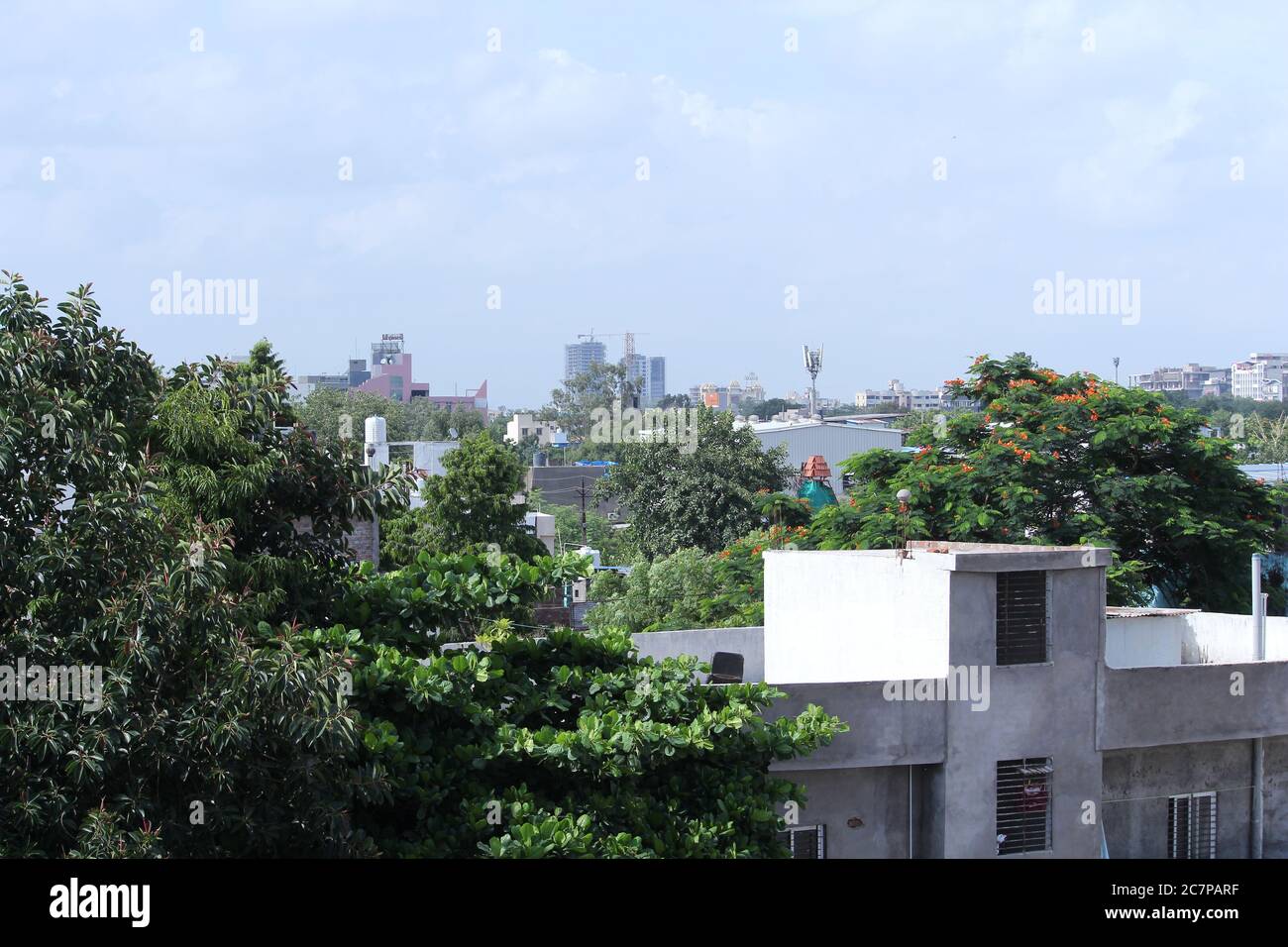 residential buildings and houses in city, Indian street sky background