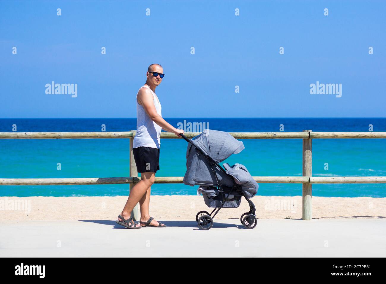 Man pushing pram on beach hires stock photography and images Alamy