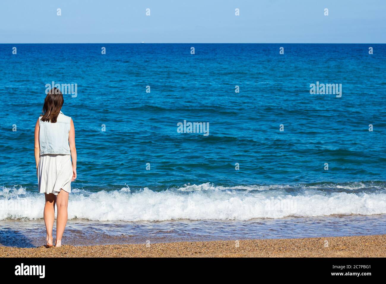 summer and travel concept - back view of woman looking at the sea Stock ...
