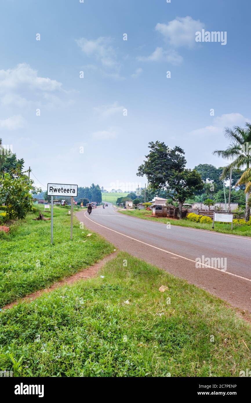 View of a road passing through a small town with house’s and vehicles