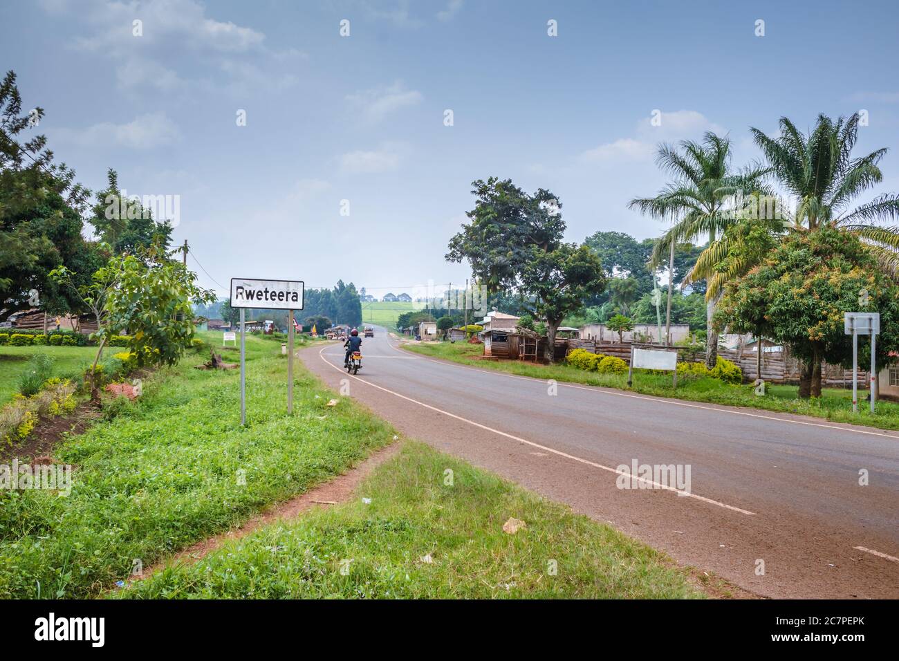 View of a road passing through a small town with house’s and vehicles