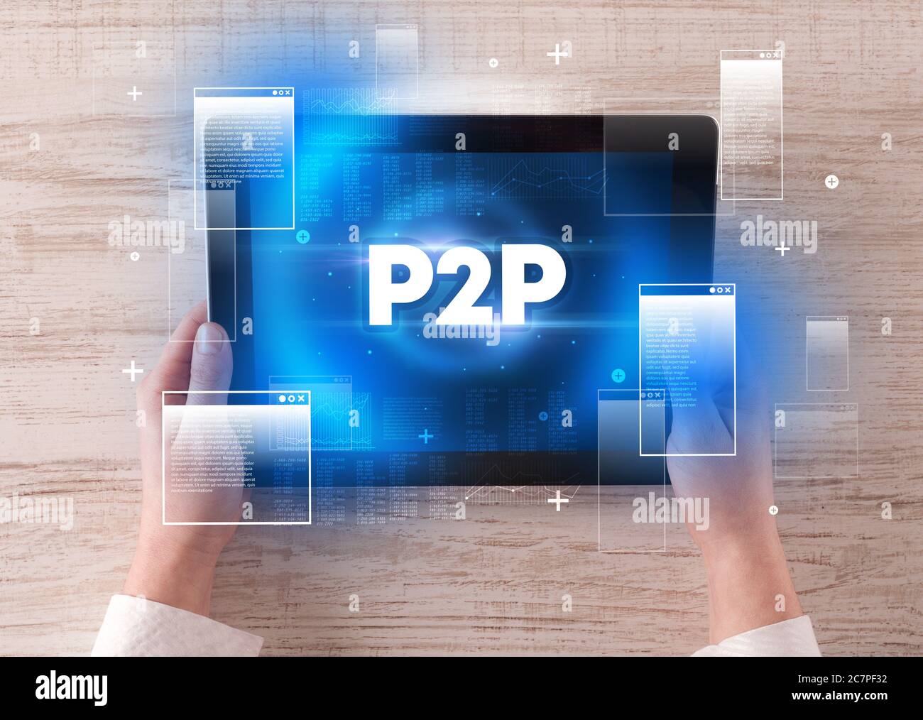 Closeup of a hand holding tablet with P2P abbreviation, modern