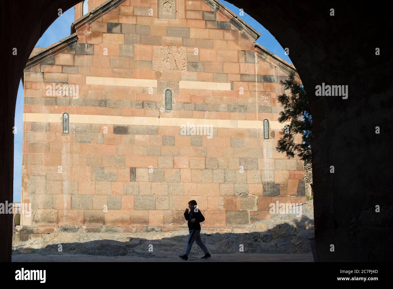 Tourists & visitors are given guided tours around the interior of St. Astvatsatsin at Khor Virap while priests go about their daily business. Armenia Stock Photo