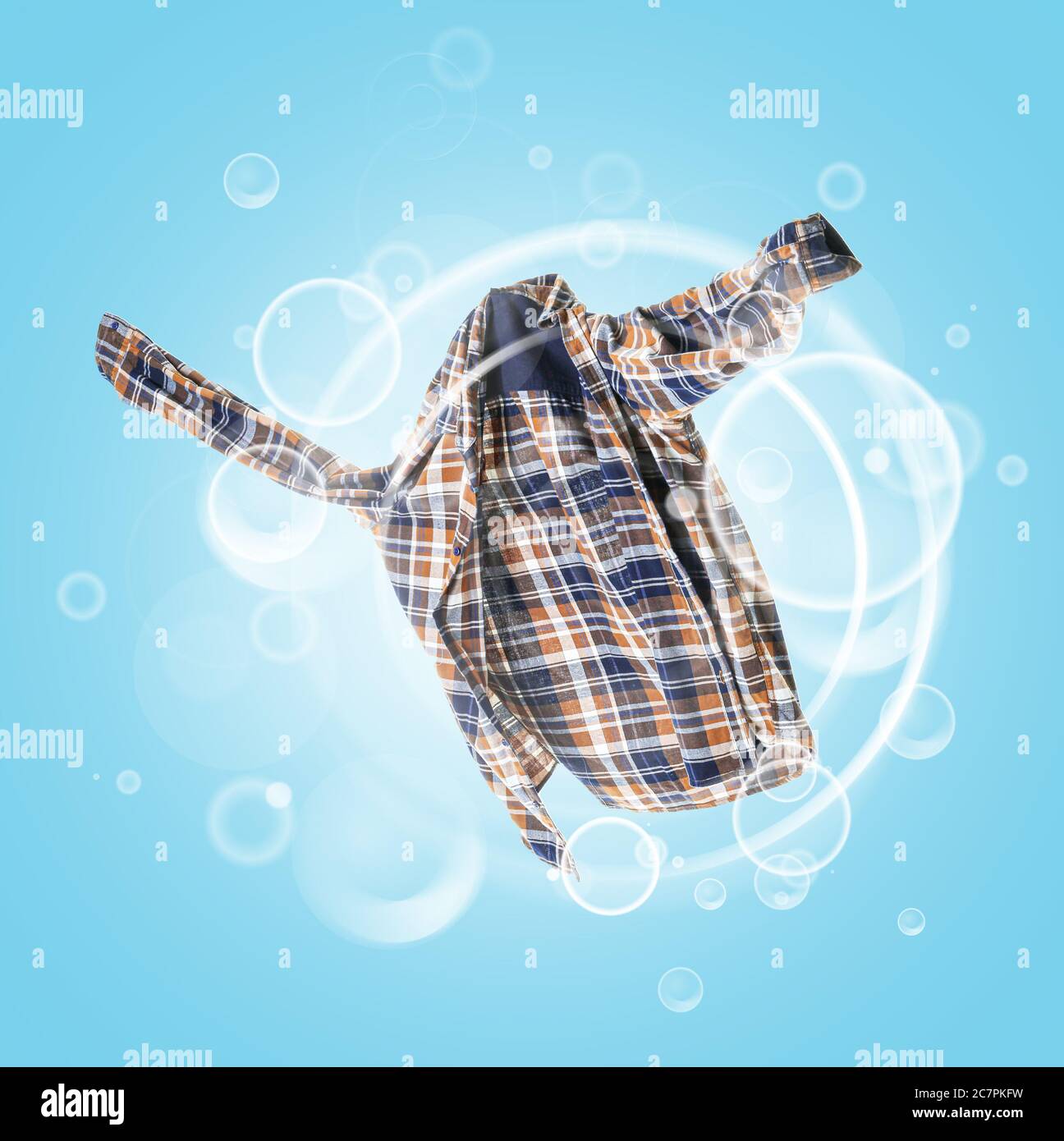 Clean shirt with soap bubbles on color background Stock Photo