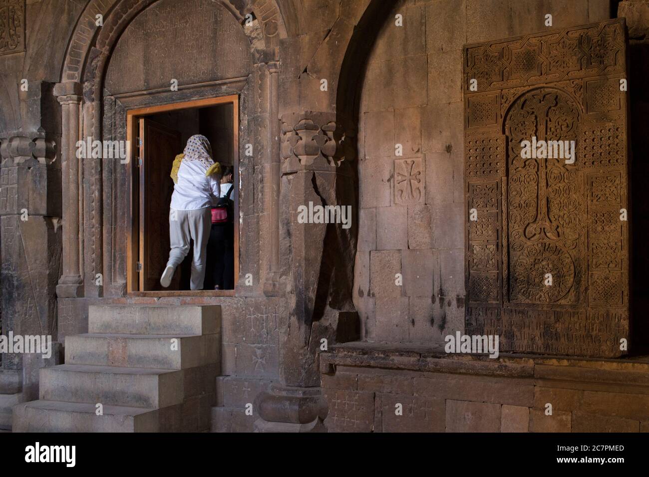 Tourists & visitors are given guided tours around the interior of St. Astvatsatsin at Khor Virap while priests go about their daily business. Armenia Stock Photo