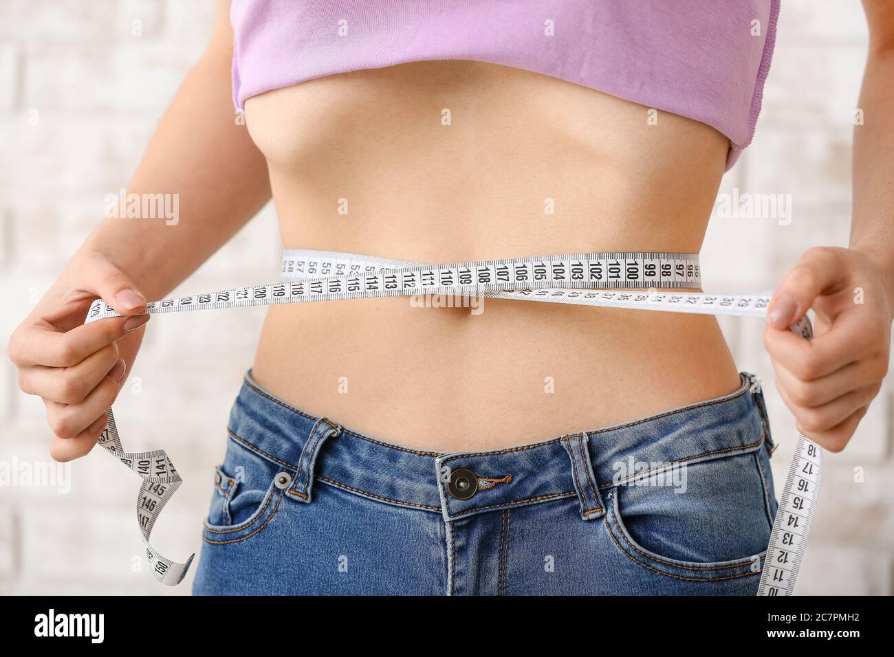 Closeup Of Tape Measure Around Woman Waist Stock Photo, Picture