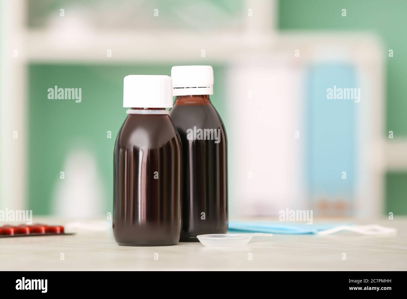 Bottles of cough syrup on table Stock Photo Alamy
