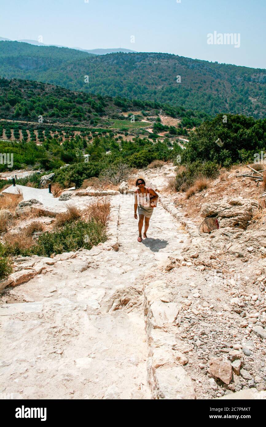 3 september 2007 Rodos Greece. struggling on the rocky path with flip flops to get to the top of the hill and enyoy the view. Stock Photo