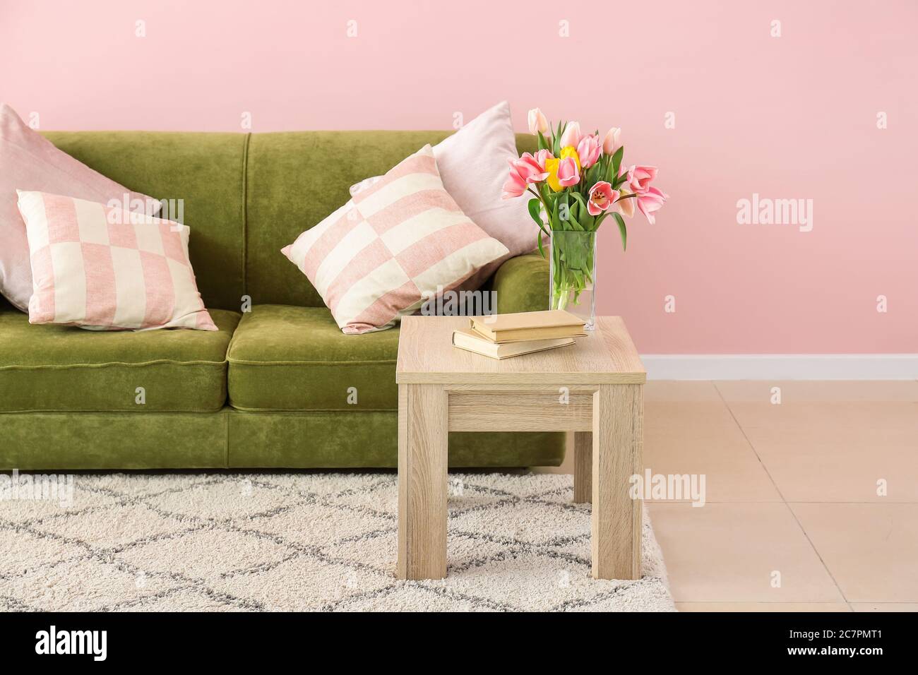 Stylish sofa with table in interior of living room Stock Photo - Alamy
