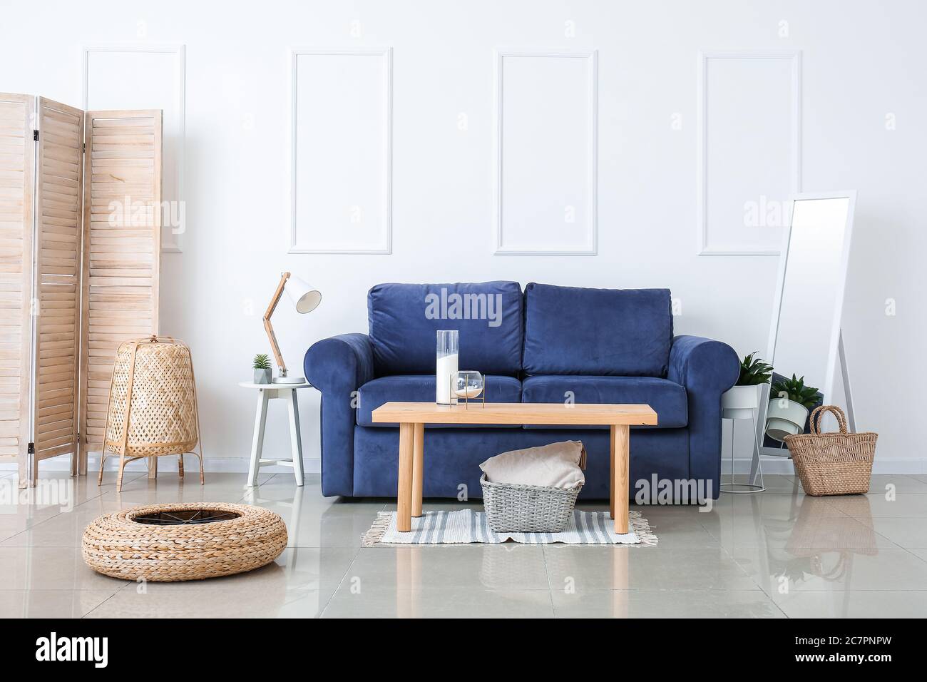 Stylish interior of living room with sofa and table Stock Photo - Alamy