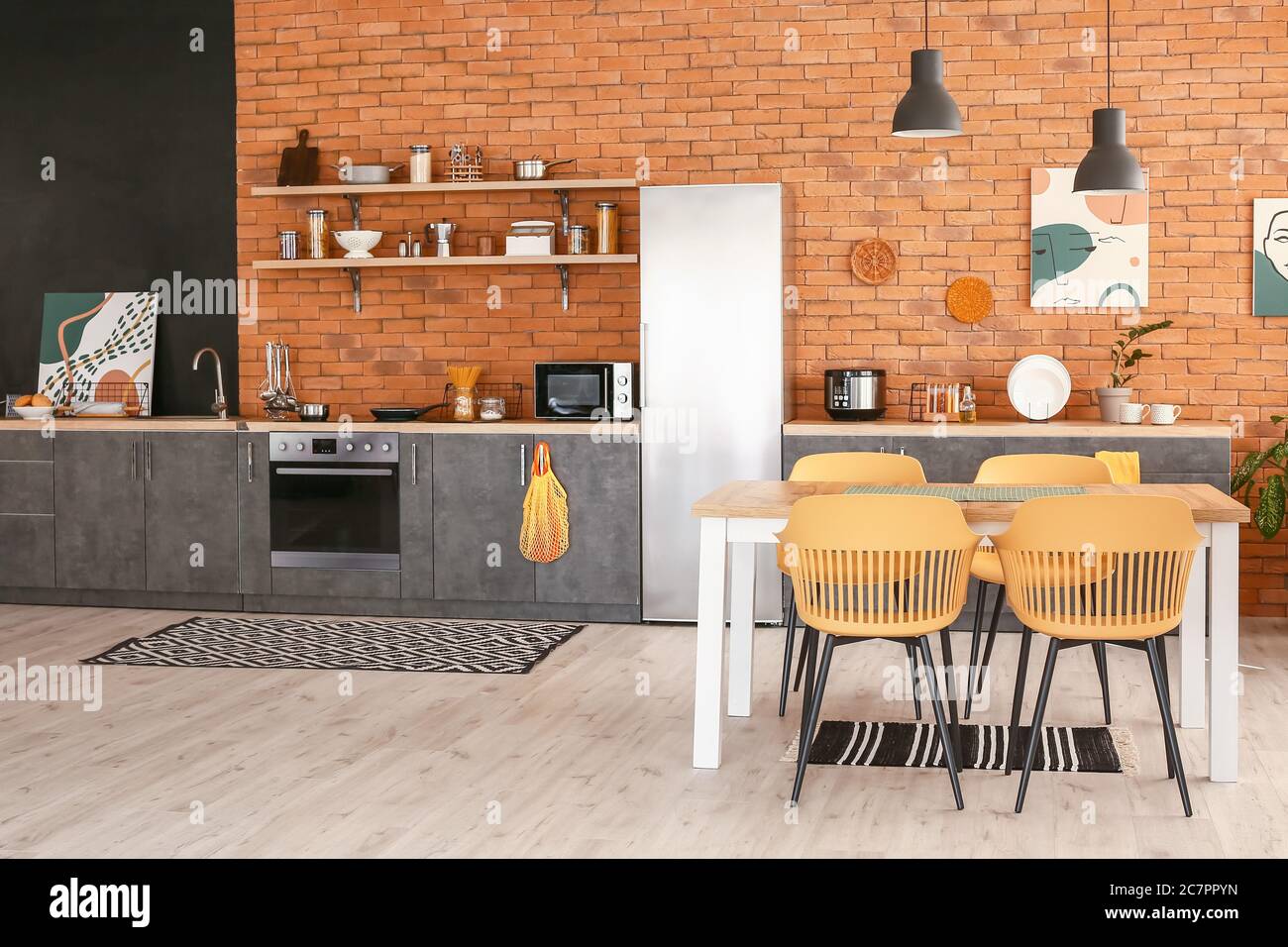 Stylish interior of modern kitchen with dining table Stock Photo - Alamy