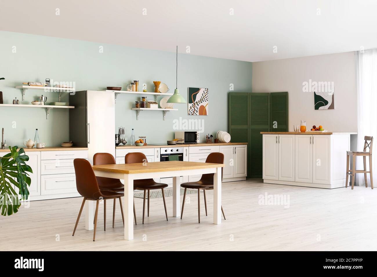 Stylish interior of modern kitchen with dining table Stock Photo - Alamy