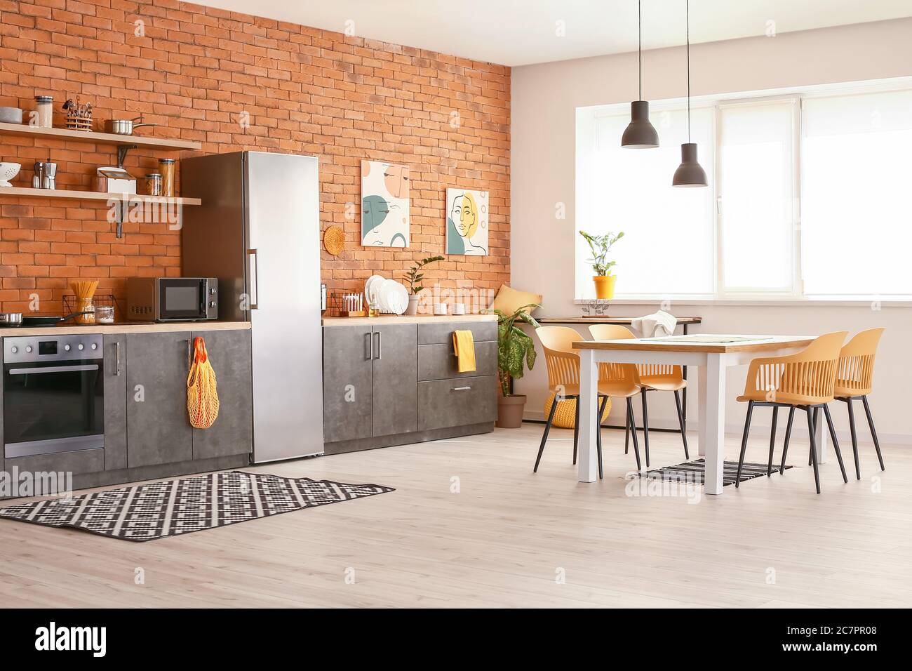 Stylish interior of modern kitchen with dining table Stock Photo - Alamy