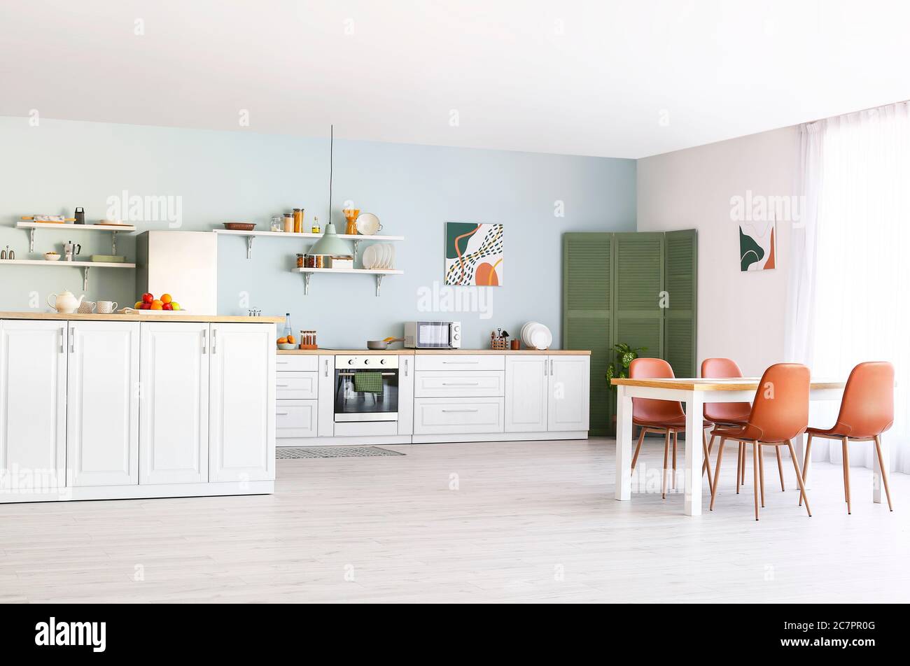 Stylish interior of modern kitchen with dining table Stock Photo - Alamy