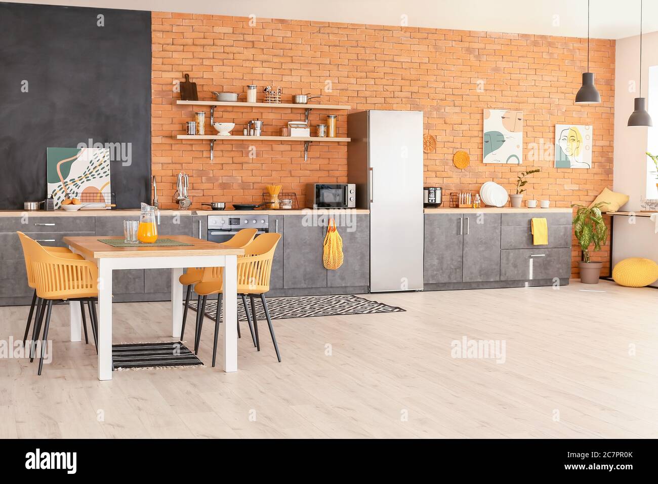 Stylish interior of modern kitchen with dining table Stock Photo - Alamy