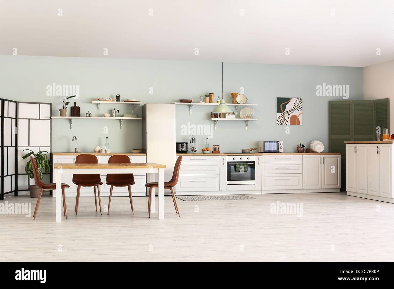Stylish interior of modern kitchen with dining table Stock Photo - Alamy
