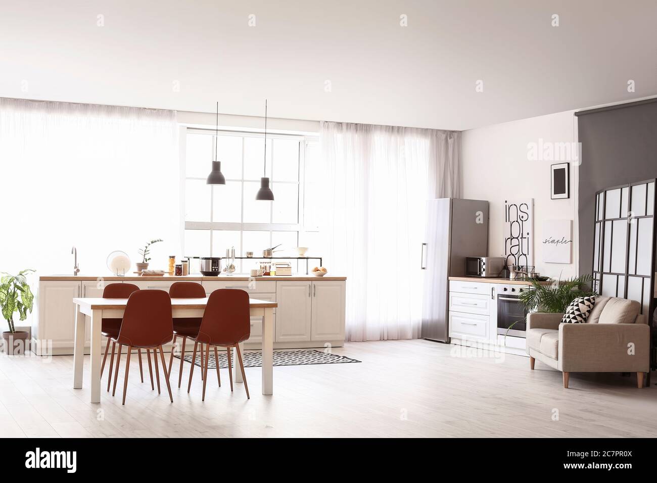 Stylish interior of modern kitchen with dining table Stock Photo - Alamy