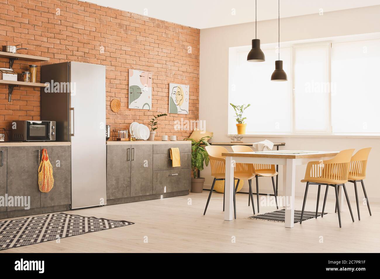 Stylish interior of modern kitchen with dining table Stock Photo - Alamy