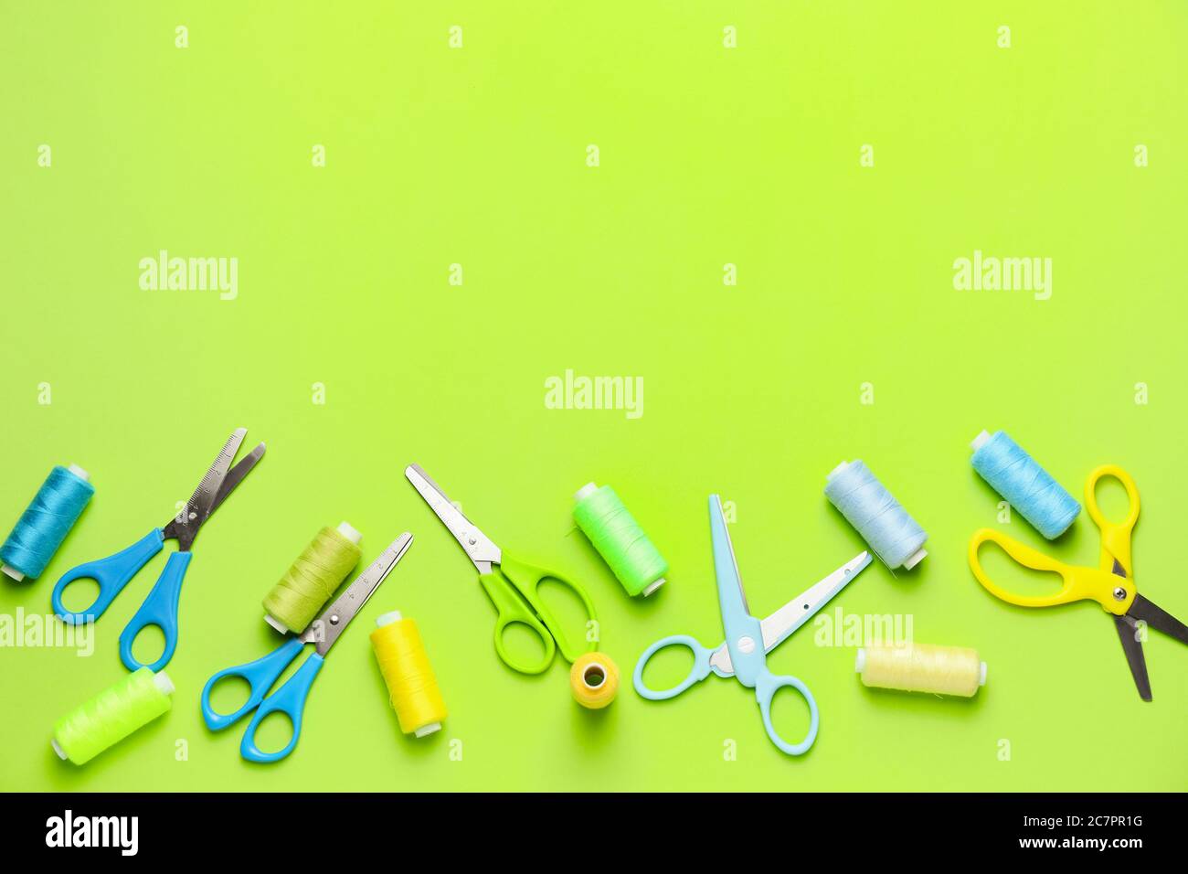 Scissors with sewing threads on color background Stock Photo