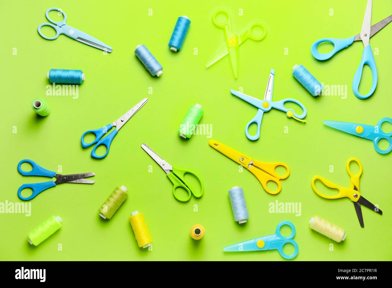 Scissors with sewing threads on color background Stock Photo
