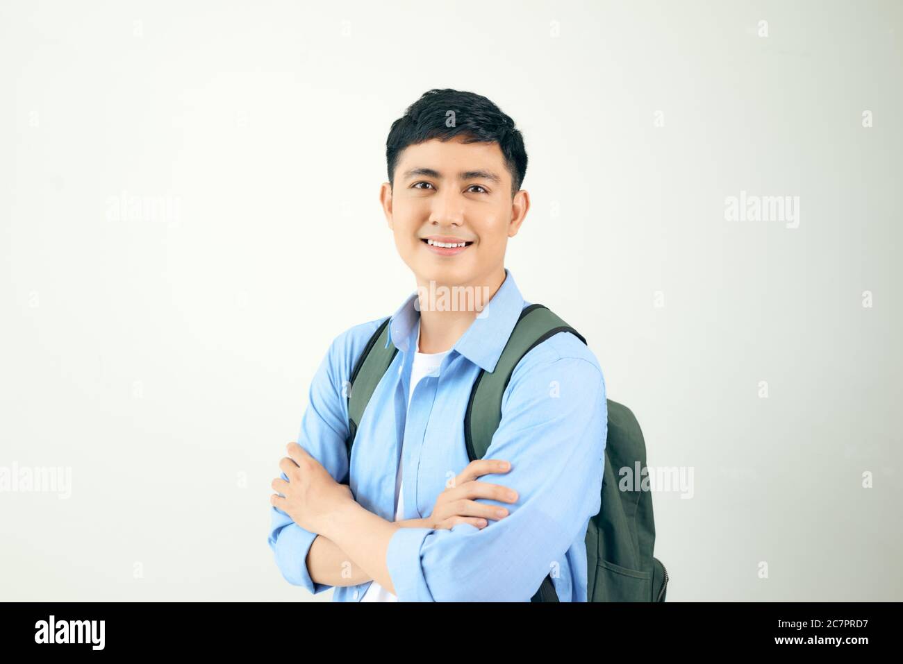 Handsome and friendly face man self-confident positive expression with crossed arms on white background Stock Photo