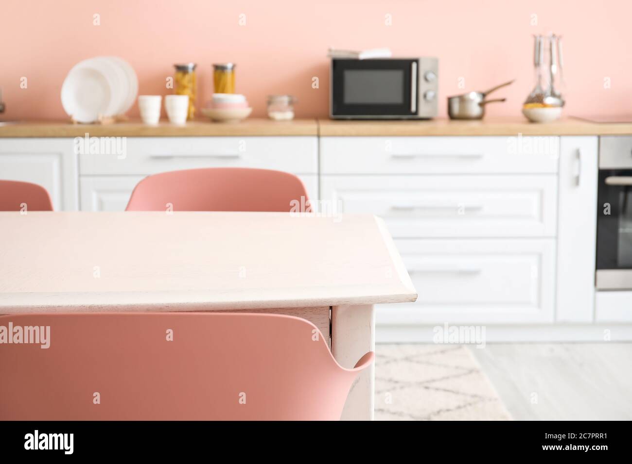 Dining table in interior of modern kitchen Stock Photo - Alamy