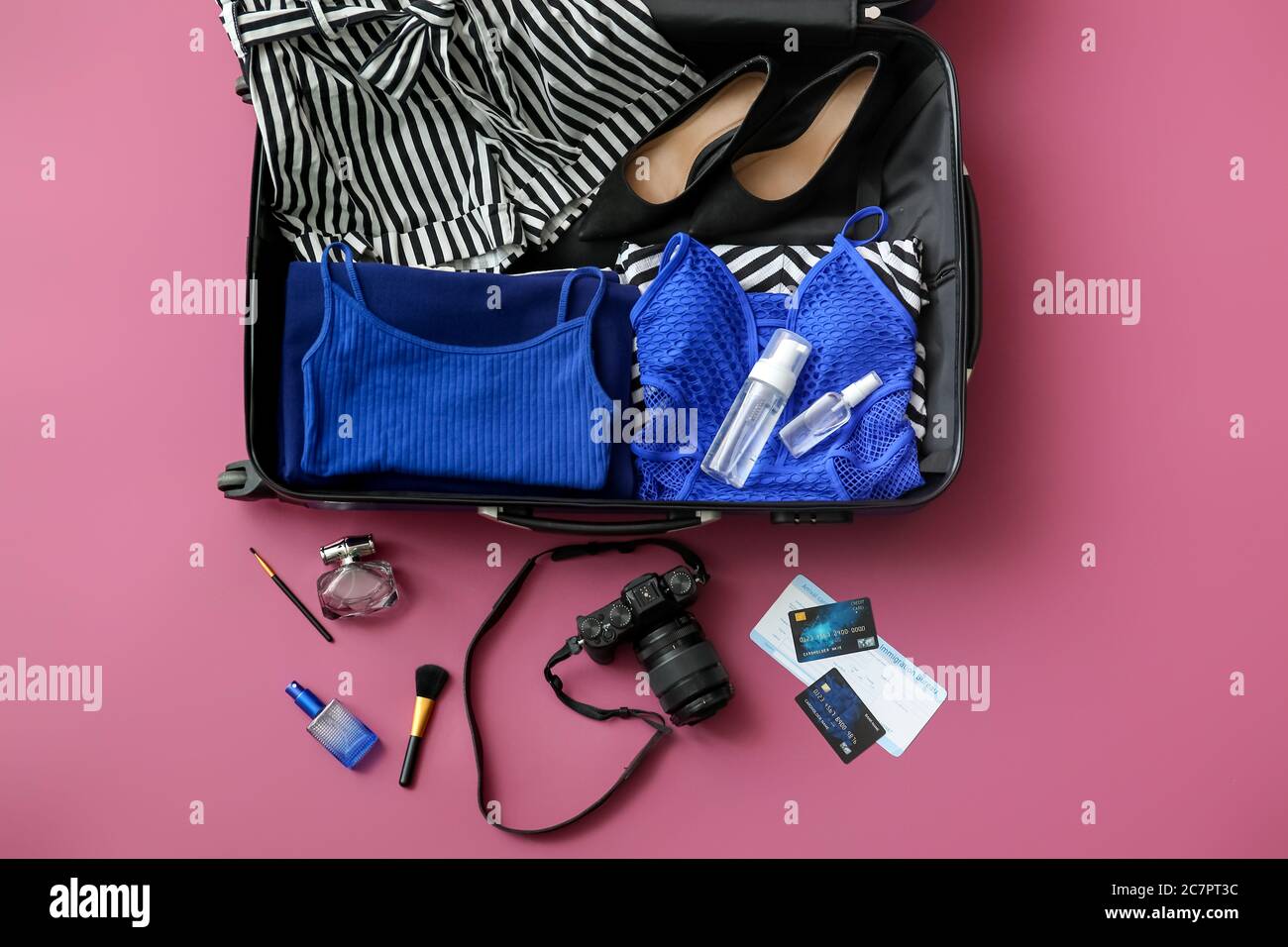 https://c8.alamy.com/comp/2C7PT3C/open-packed-suitcase-and-accessories-on-color-background-2C7PT3C.jpg