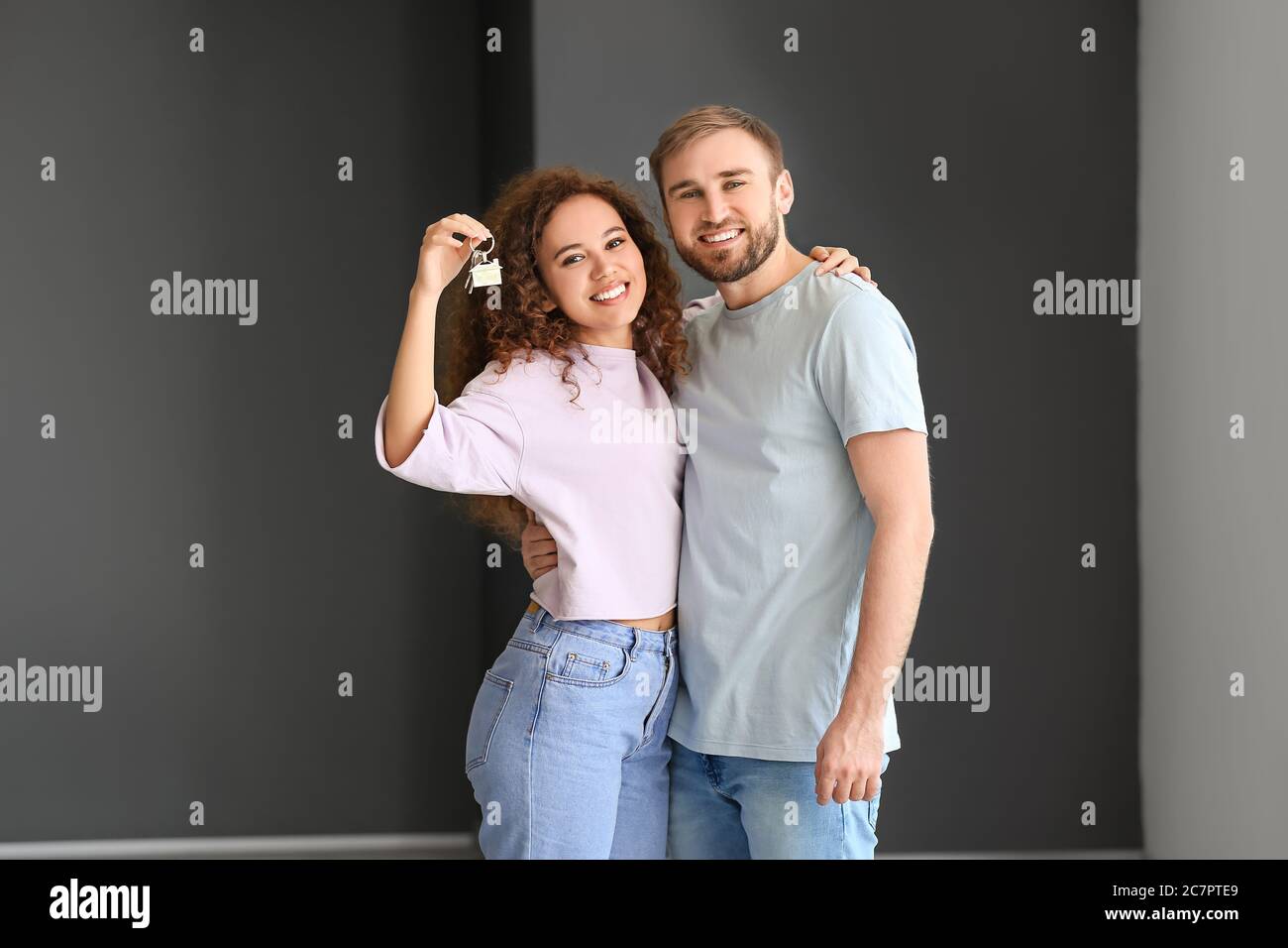 Happy young couple with key in their new flat Stock Photo - Alamy