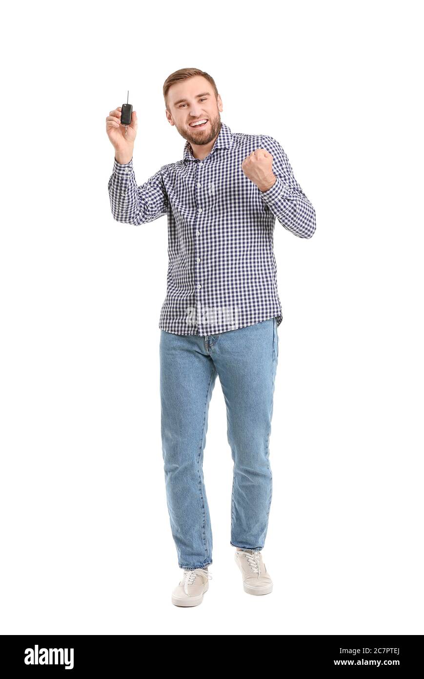 Happy man with car key on white background Stock Photo - Alamy