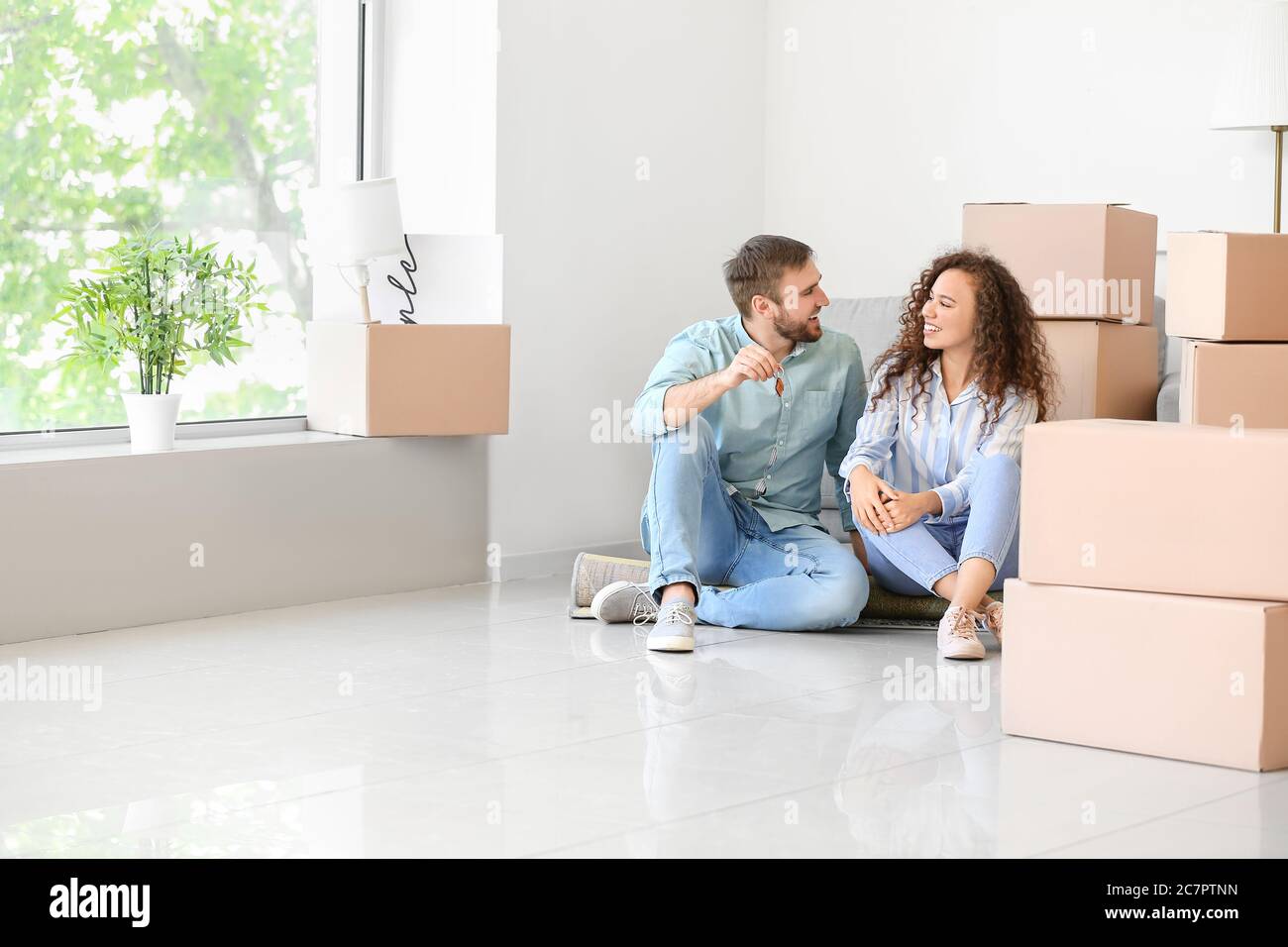 Happy young couple in their new flat on moving day Stock Photo - Alamy
