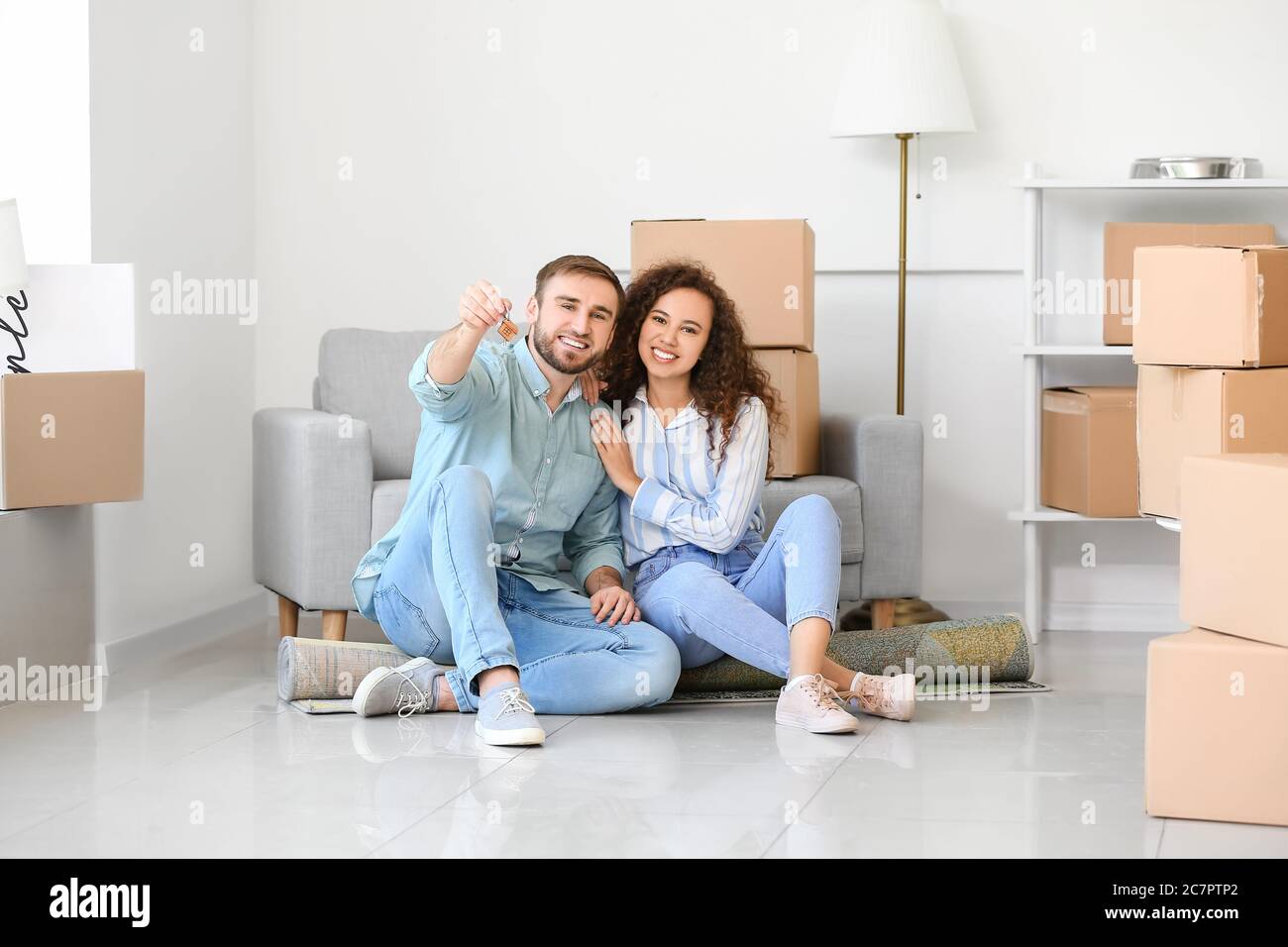 Happy young couple in their new flat on moving day Stock Photo - Alamy