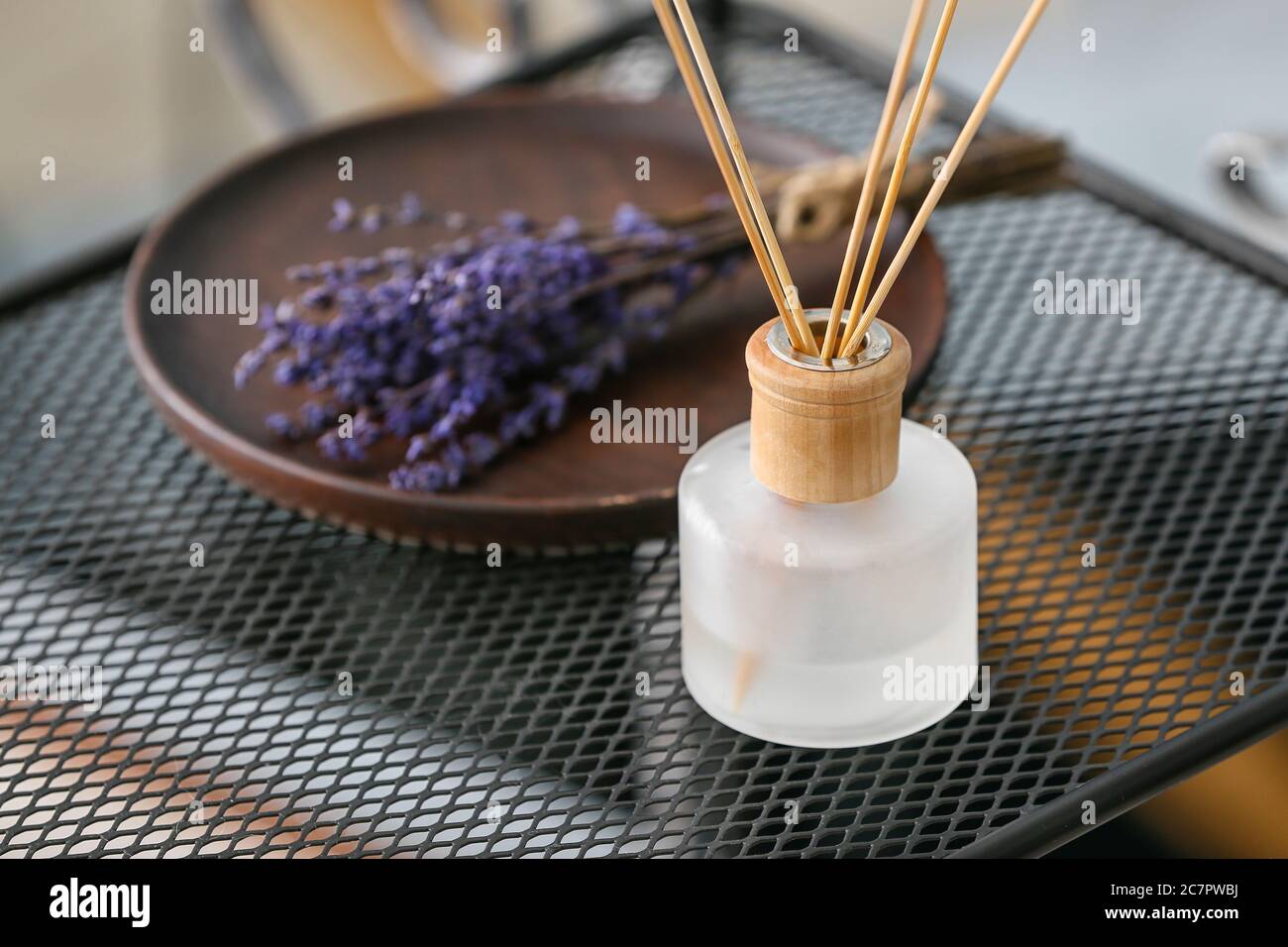 Reed diffuser on table in room Stock Photo - Alamy