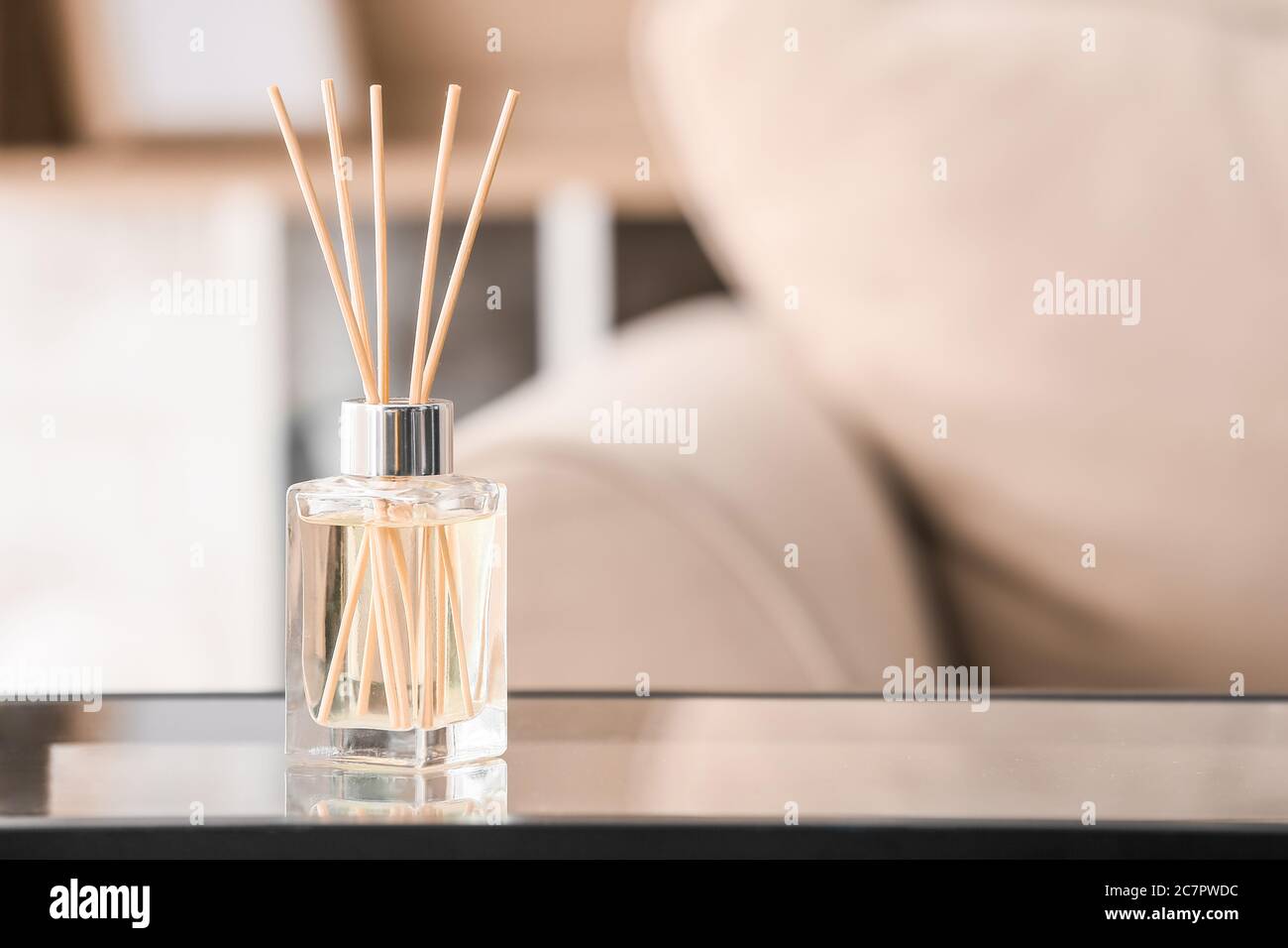 Reed diffuser on table in room Stock Photo