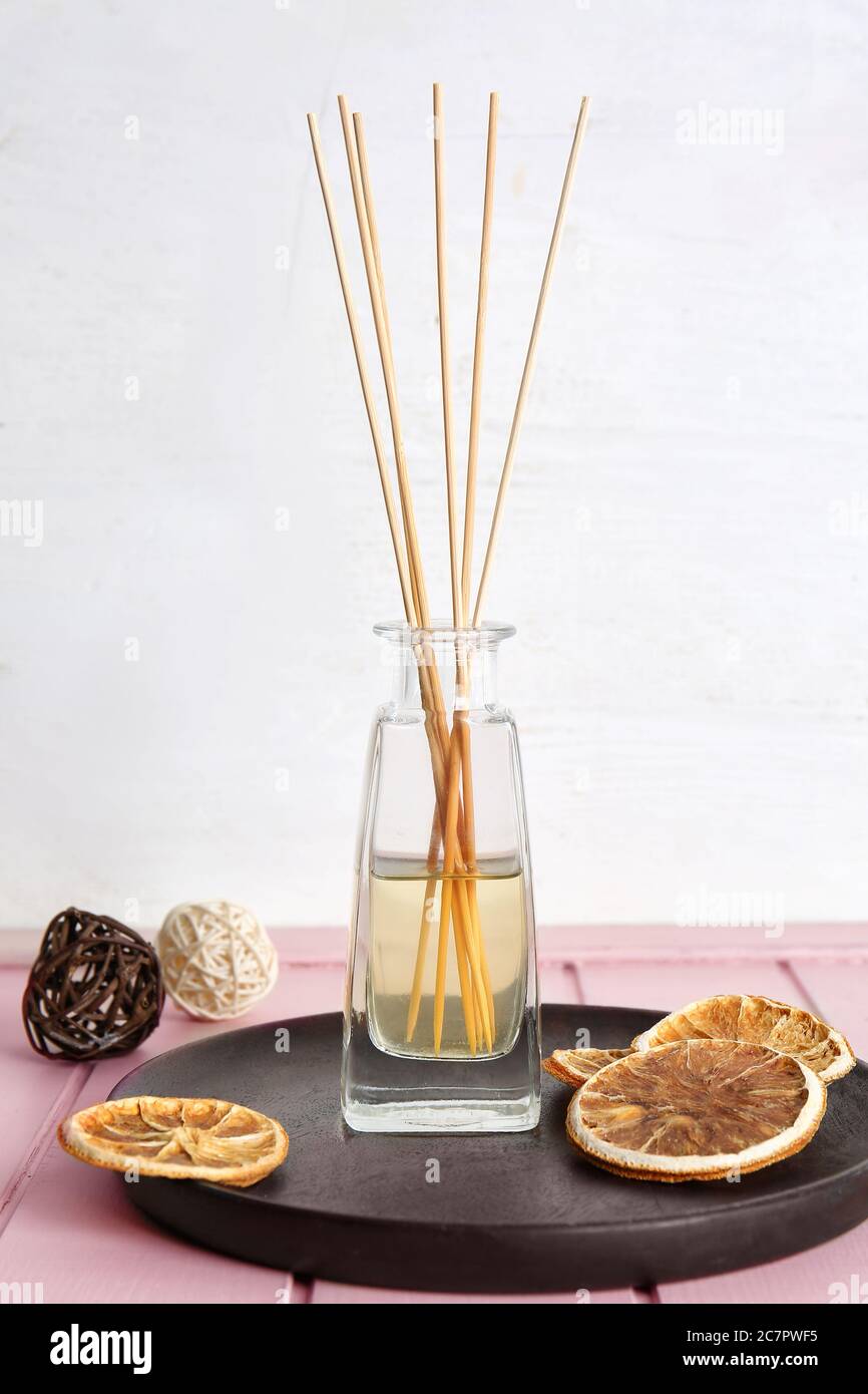 Citrus reed diffuser on table in room Stock Photo