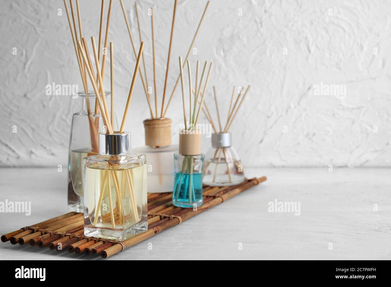 Different reed diffusers on table in room Stock Photo
