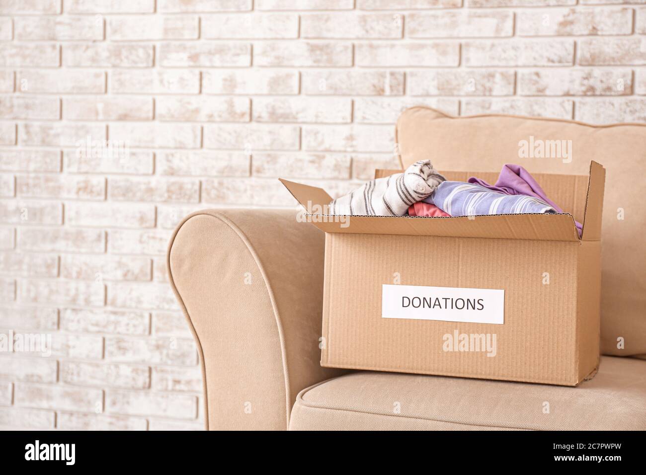Box with donations on sofa Stock Photo Alamy