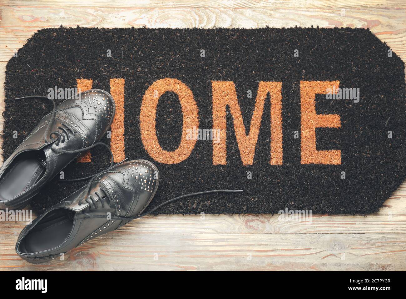 Door mat and shoes on floor Stock Photo Alamy
