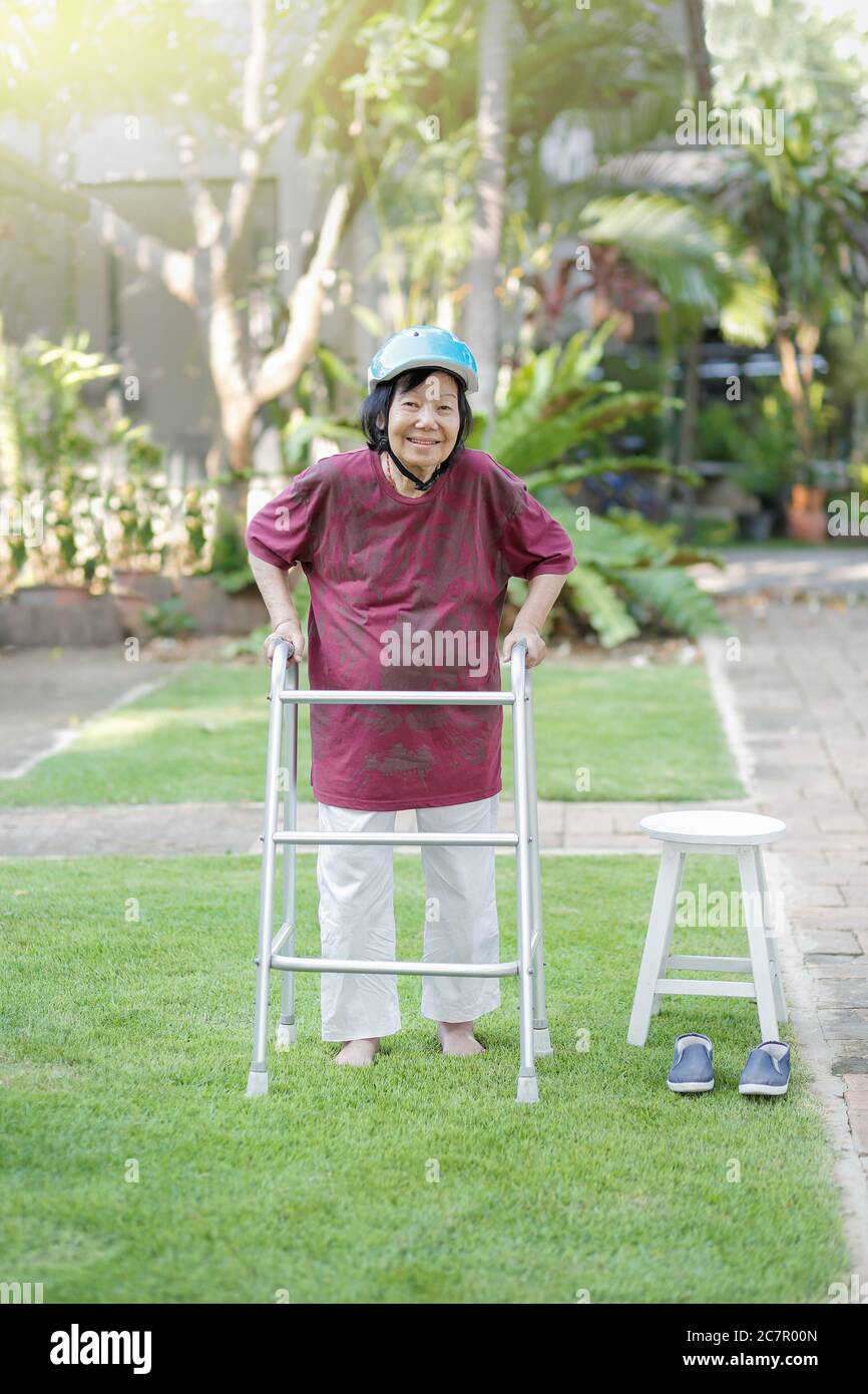 Elderly woman walking barefoot therapy on grass in backyard Stock Photo Alamy