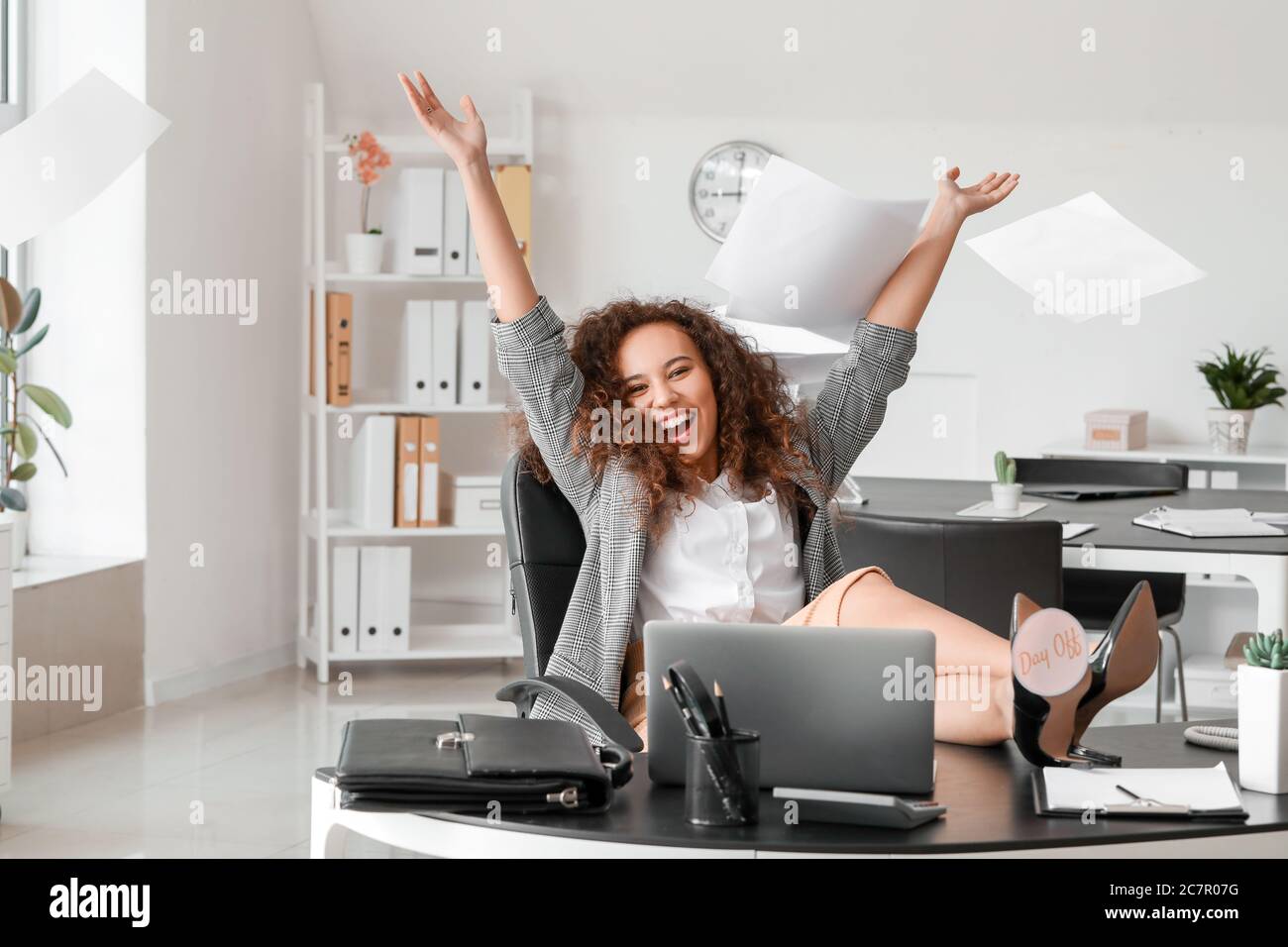 Happy businesswoman before weekends in office Stock Photo