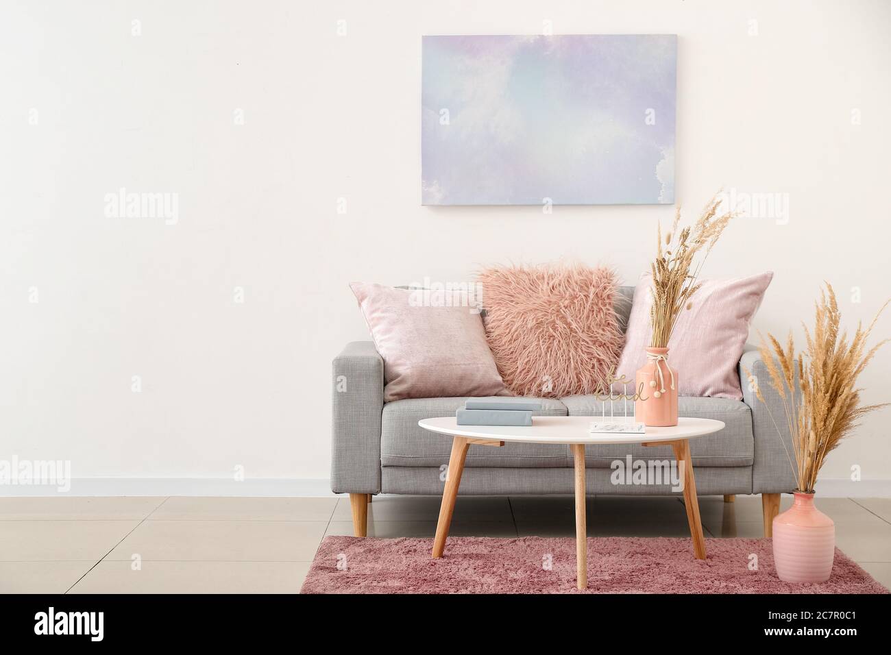 Interior of modern room with table and sofa Stock Photo - Alamy