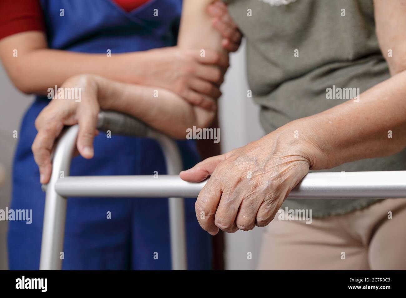 Elderly asian woman using a walker at home with daughter take care Stock Photo