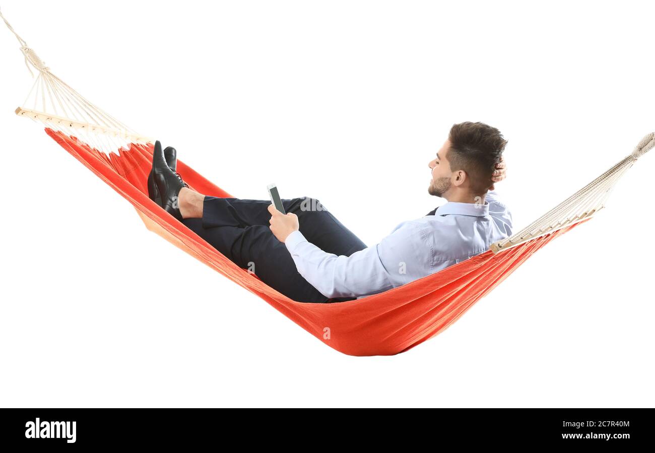 Young businessman with mobile phone relaxing in hammock against white  background Stock Photo - Alamy