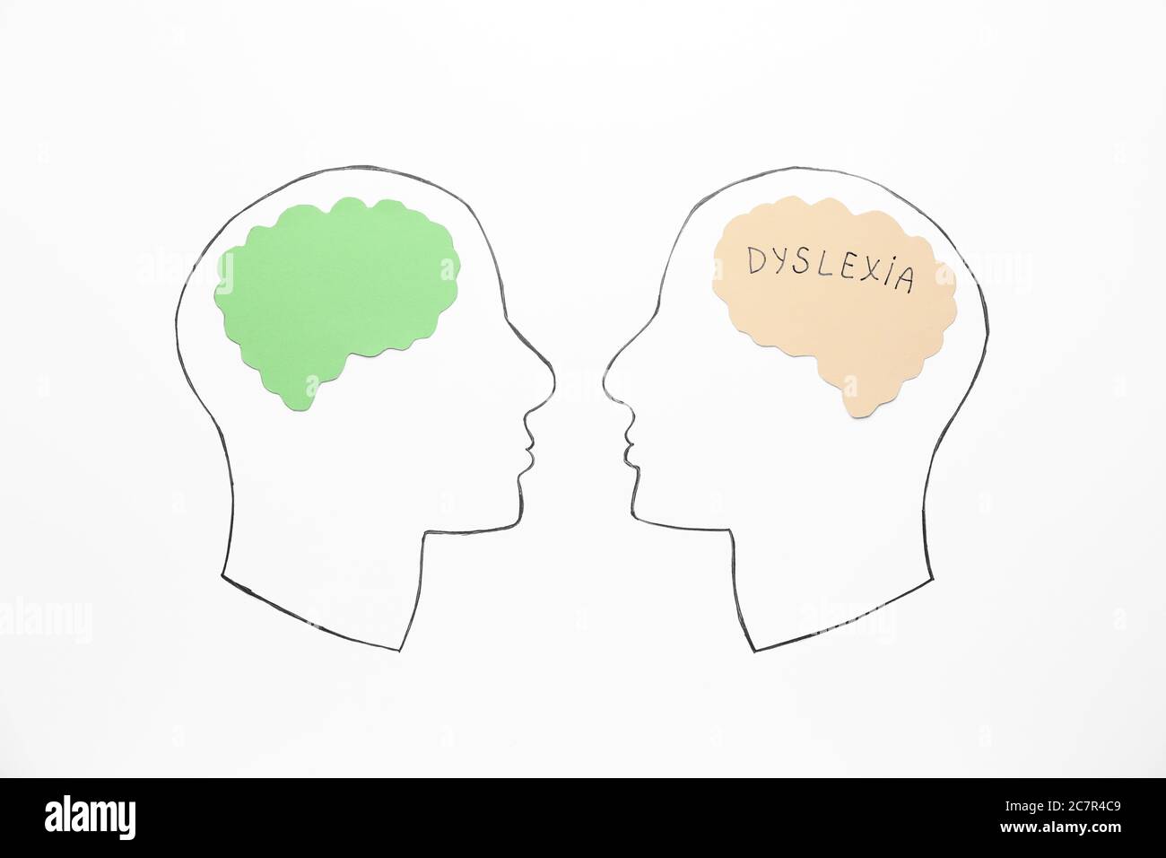 Drawn human heads on white background. Dyslexia concept Stock Photo - Alamy