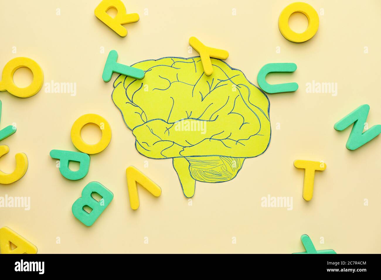 Paper brain and letters on color background. Dyslexia concept Stock
